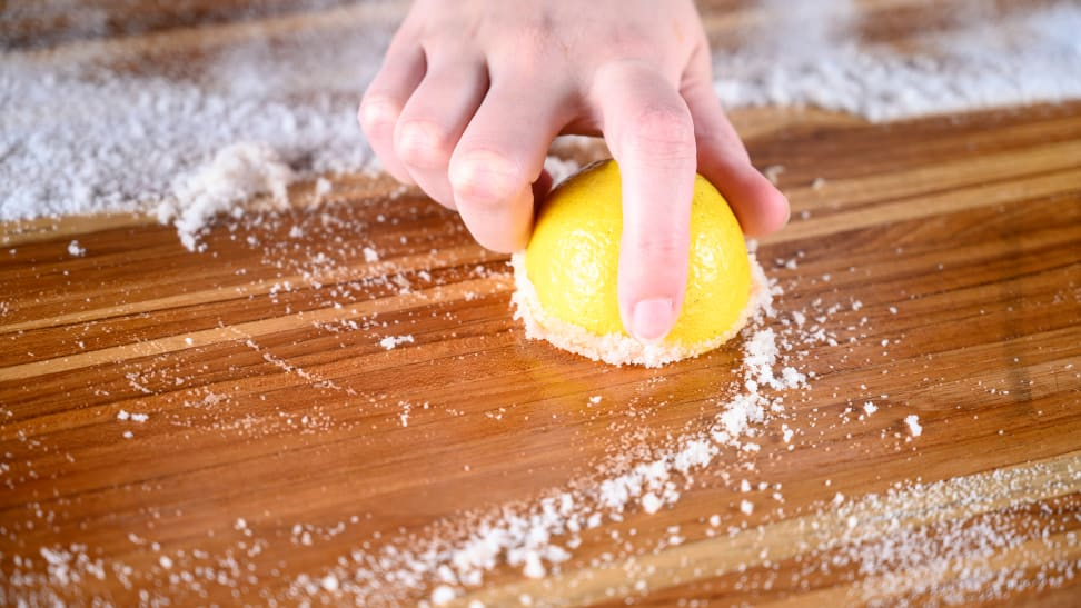Cleaning A Wood Cutting Board With Lemon And Salt